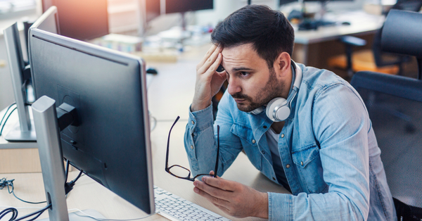 frustrated-businessman-struggling-with-outdated-av-technology-at-desk