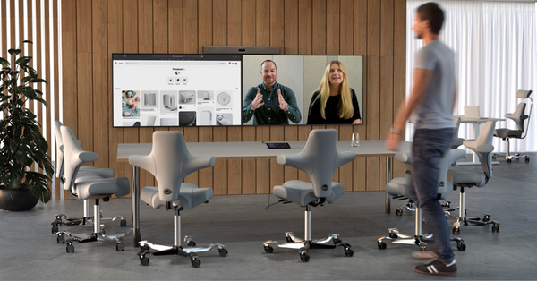 Modern-conference-room-with-video-collaboration-setup-and-dual-display-screens