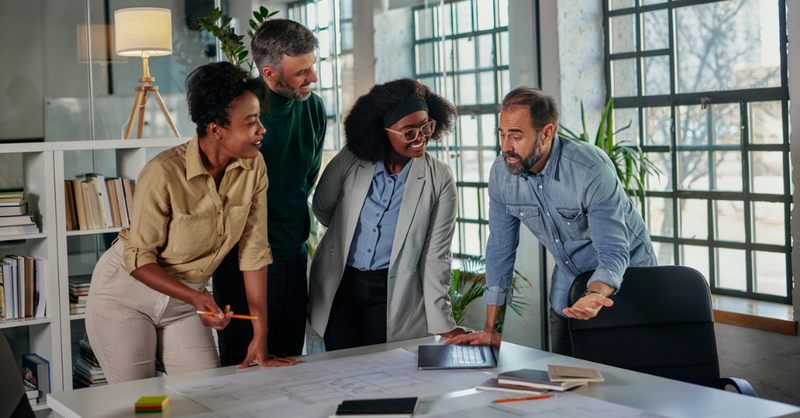 diverse-team-collaborating-in-modern-office-environment-around-project-table