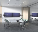 Modern conference room featuring dual displays with Logitech Rally cameras, a sleek table with integrated touch control panel, ergonomic chairs, and advanced AV solutions for seamless collaboration.